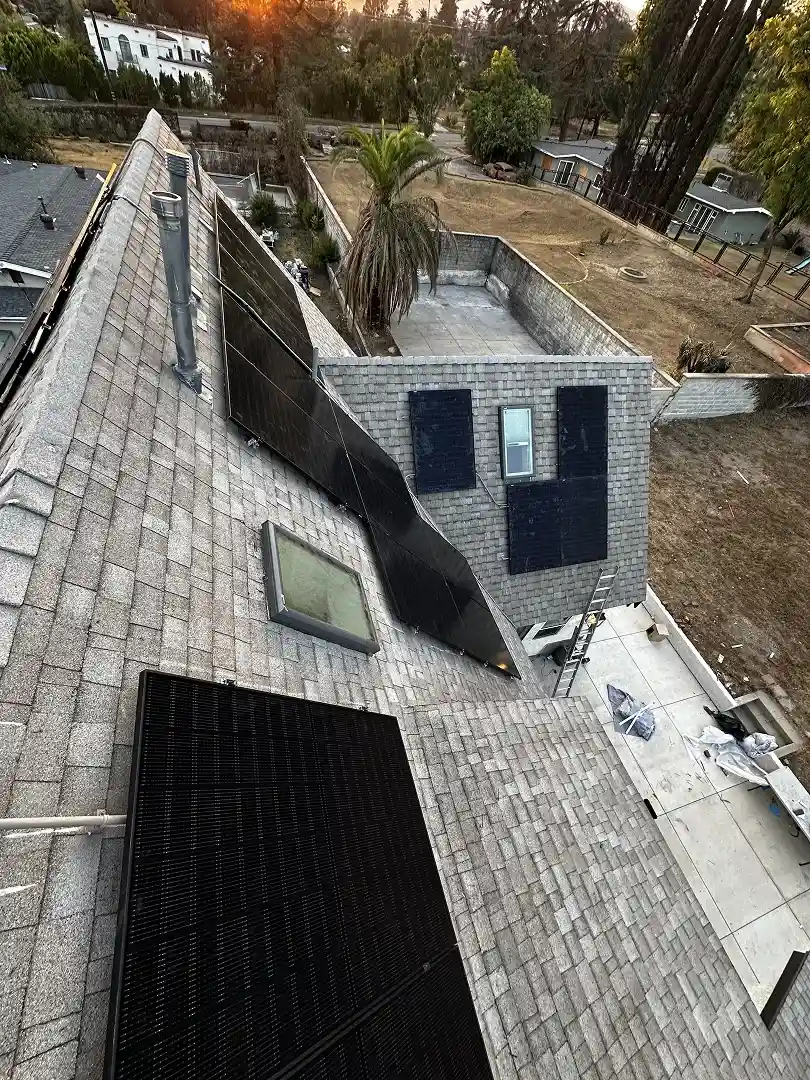 Solar installation on Altadena rooftop at sunset golden hour with foothills behind