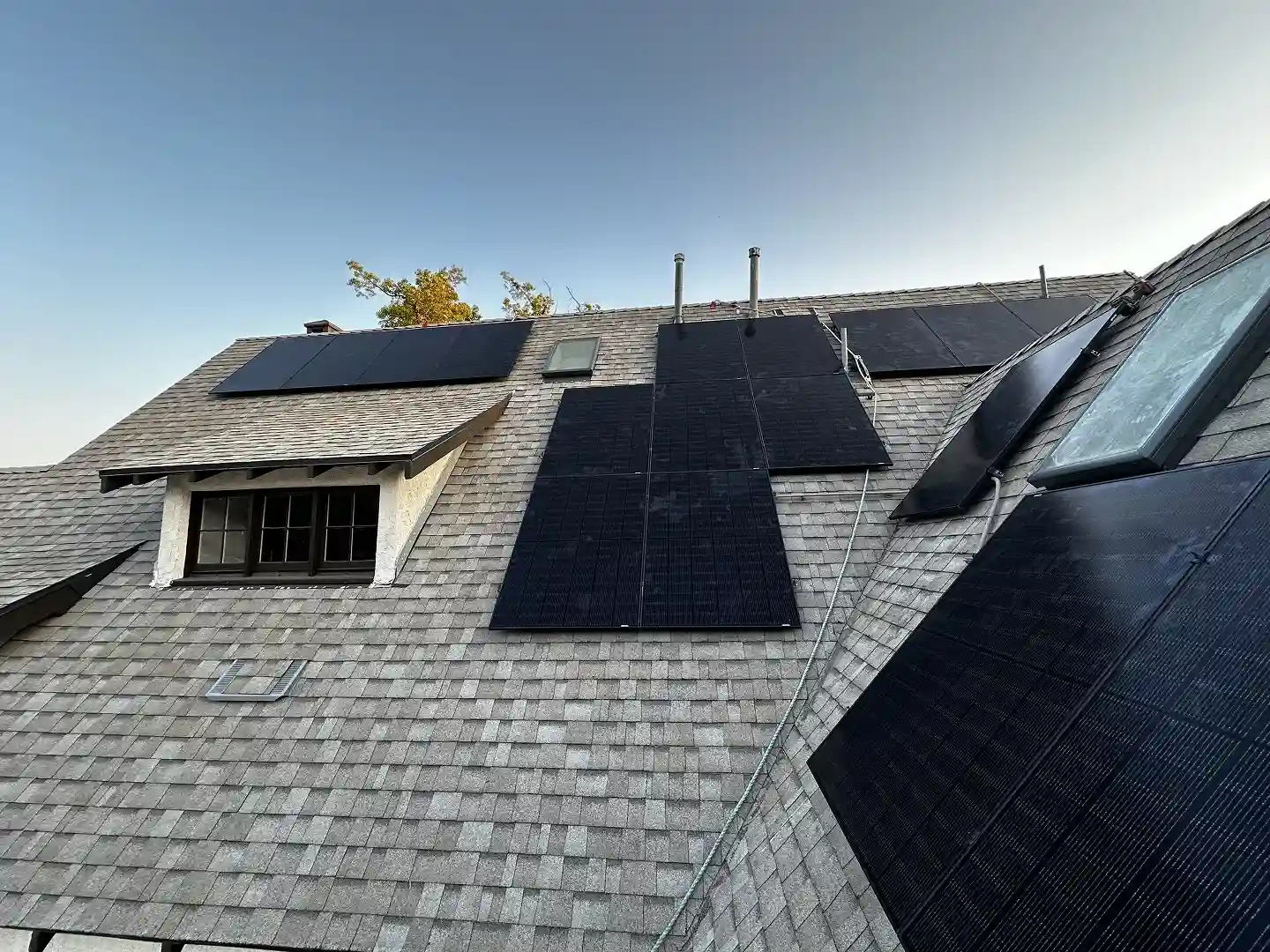 Completed solar panel installation on residential rooftop in Altadena CA with chimney and skylight