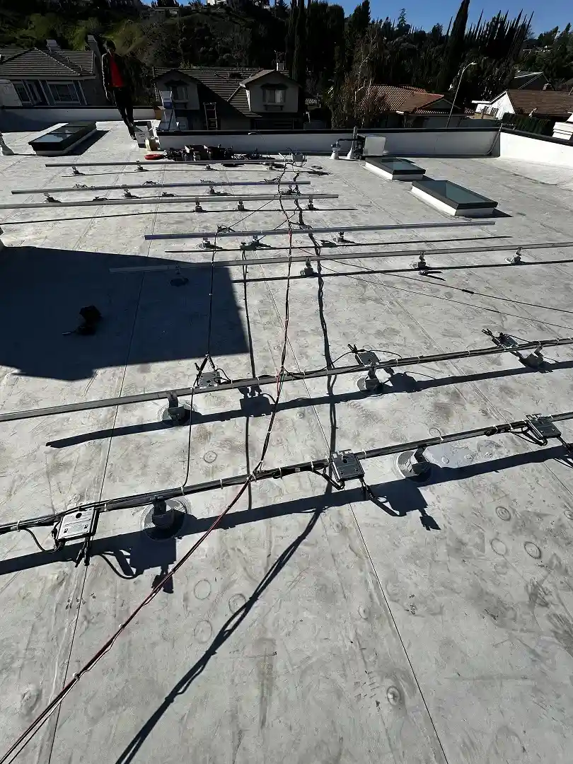 Pro Solar tilt-up racking and standoffs installed on flat tile roof before panels, Porter Ranch CA
