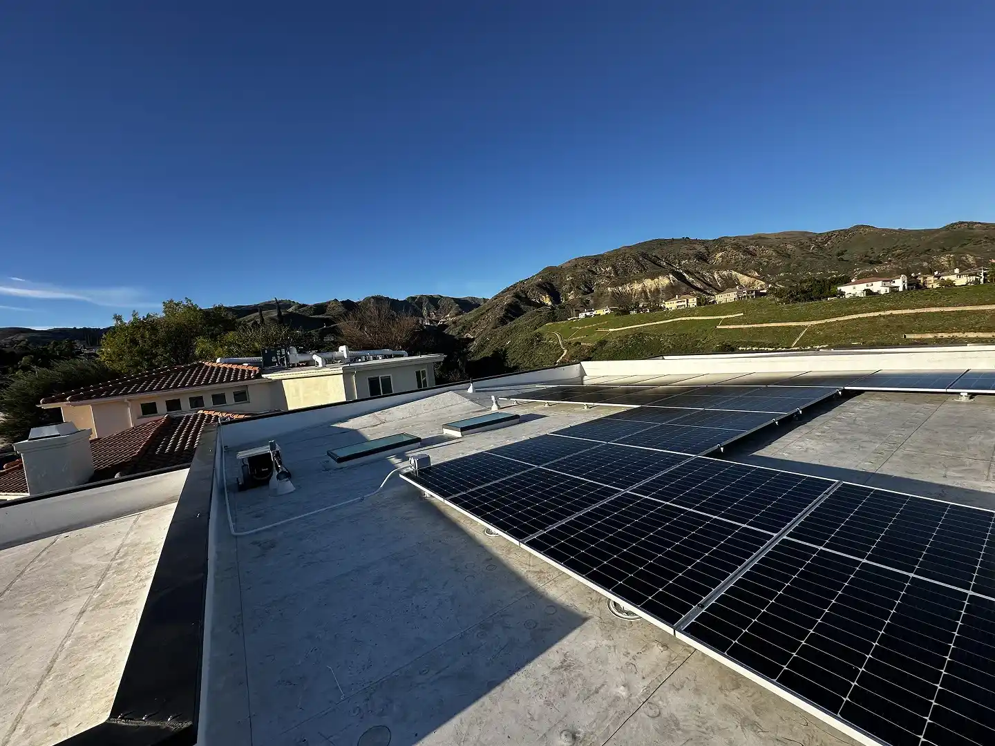 Completed 13.8 kW solar installation on new-construction Porter Ranch home with sunset