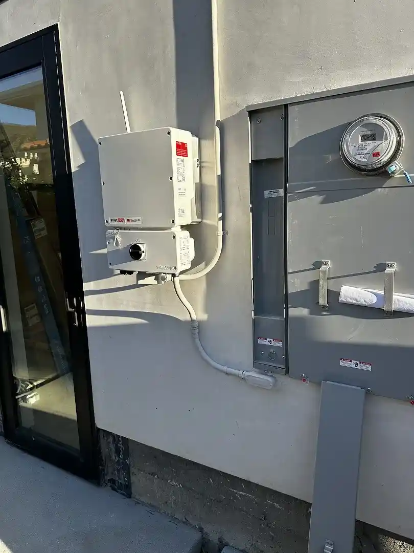 SolarEdge SE11400H-US inverter and AC disconnect installed on home exterior, Porter Ranch CA
