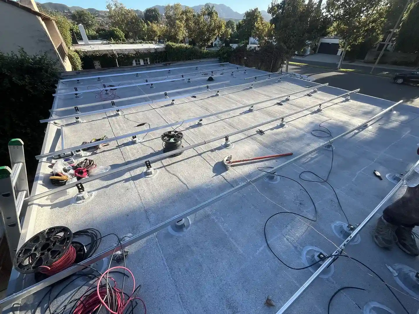 Solar racking installation in progress on flat garage roof, Westlake Village CA