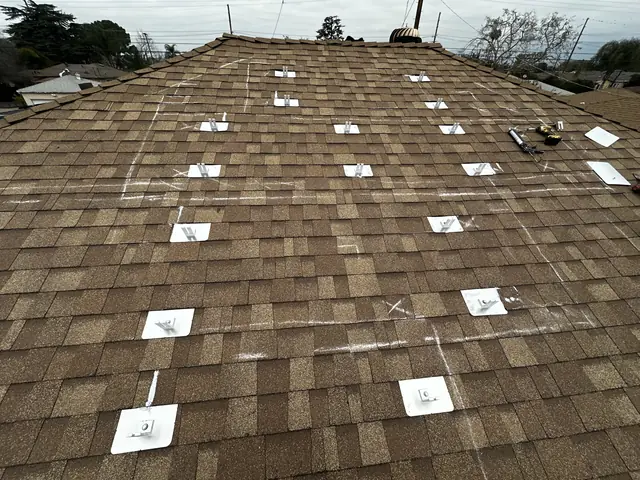A composition shingle roof chalked with layout lines and flashing plates laid out in position before any rails, Arleta, Los Angeles