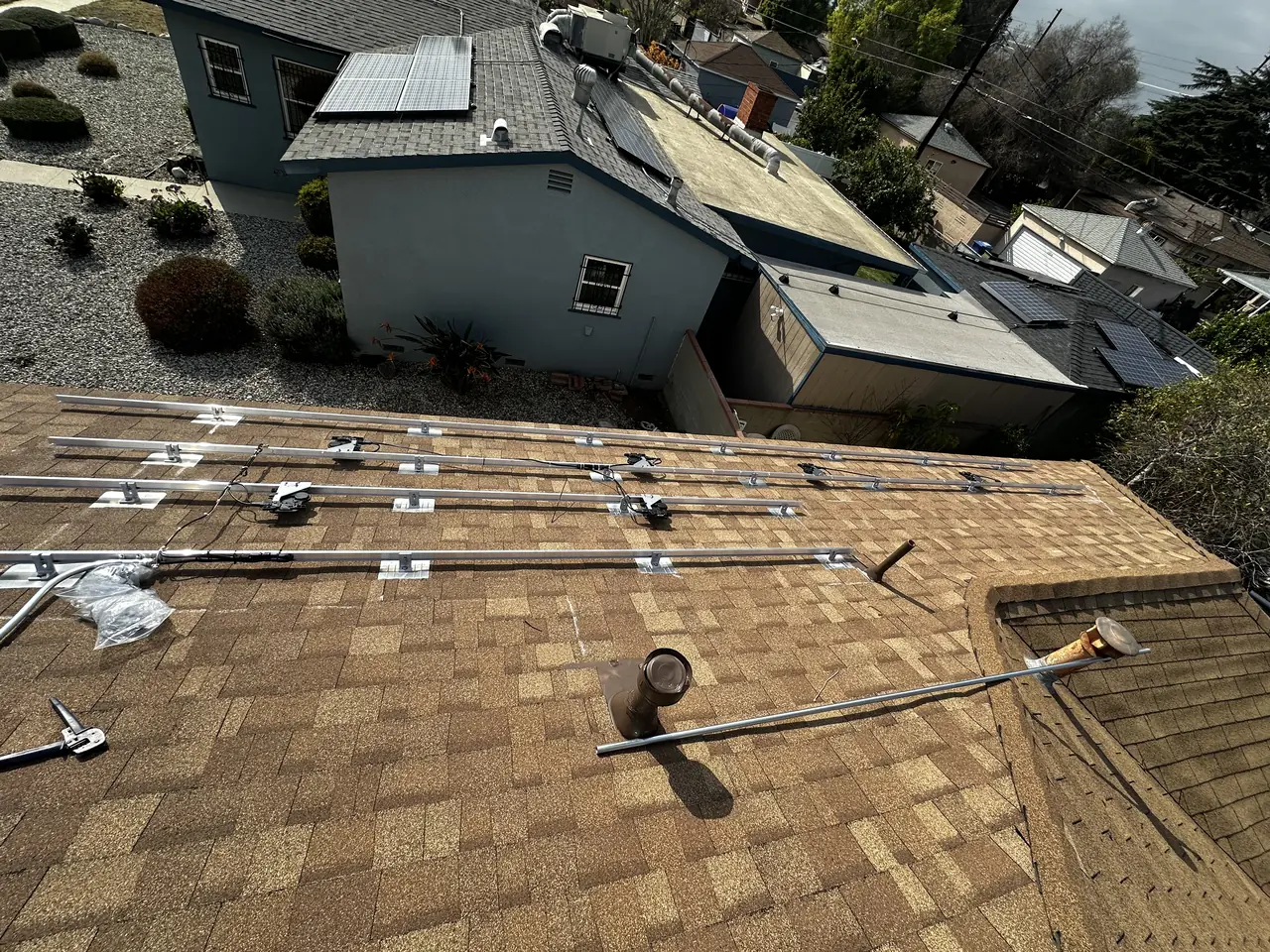 Mounting rails set along the marked lines on a composition shingle roof, Arleta, Los Angeles