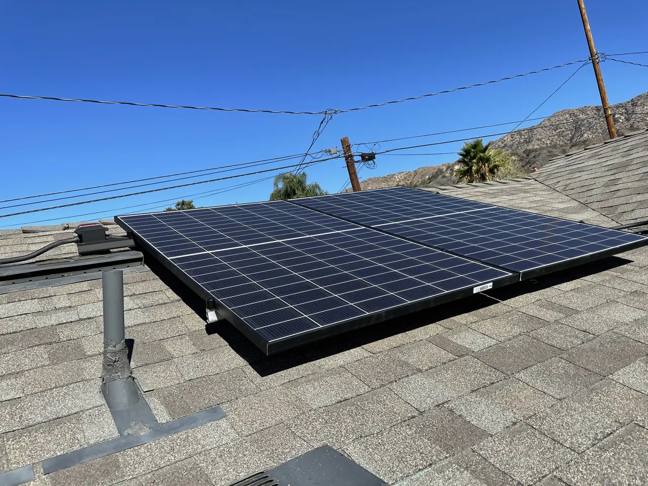 Solar array on the composition shingle roof of a new accessory dwelling in Burbank, with clear roof left around the array edges