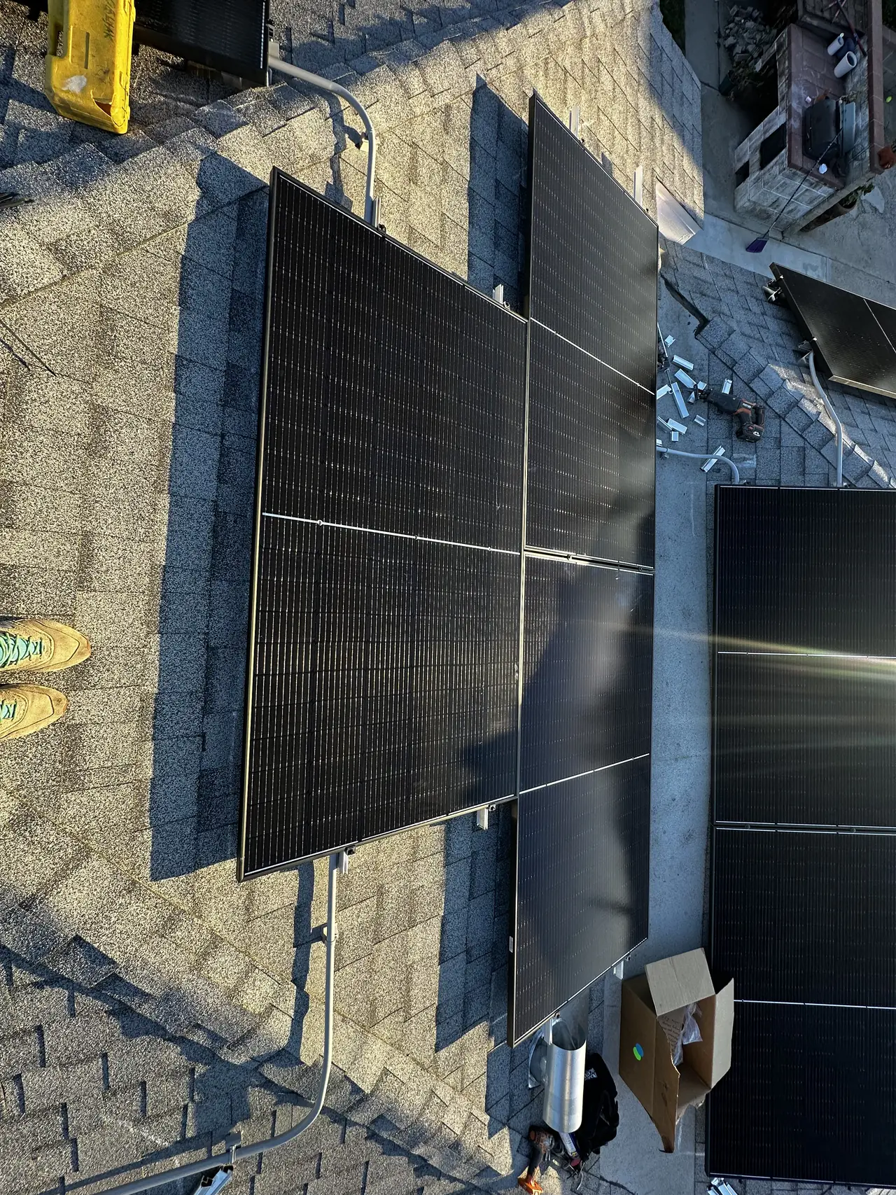 Solar modules being installed on two roof faces of a Burbank house with rails visible on both