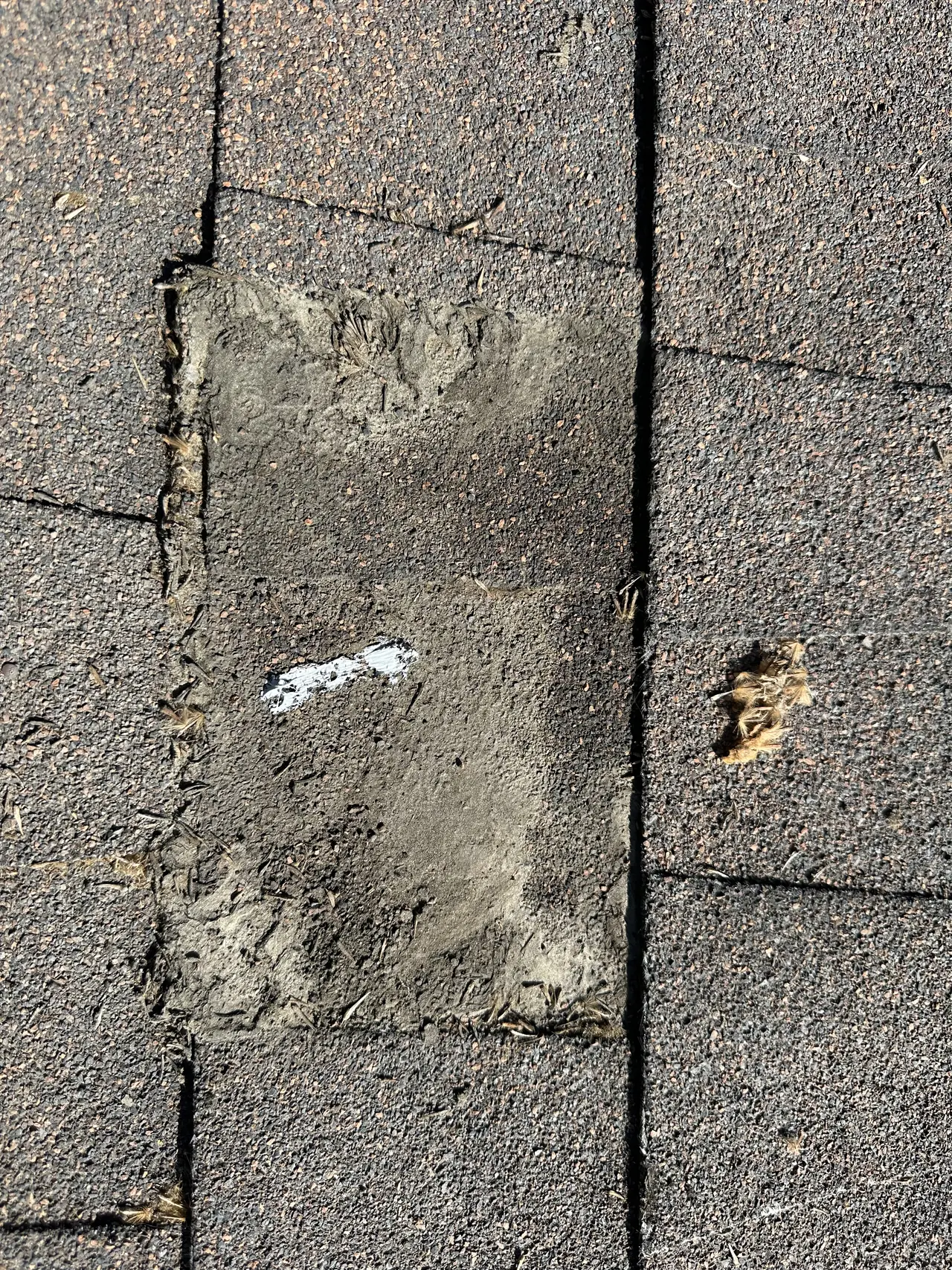 Old sealed roof penetration on weathered shingles in Burbank where a solar attachment has been removed