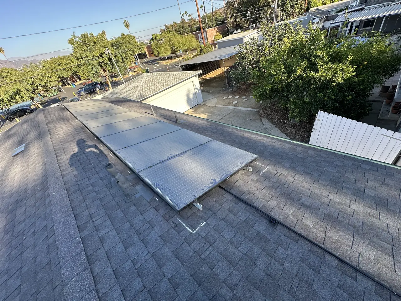 Solar modules reinstalled on a new shingle roof in Burbank seen across the roof plane