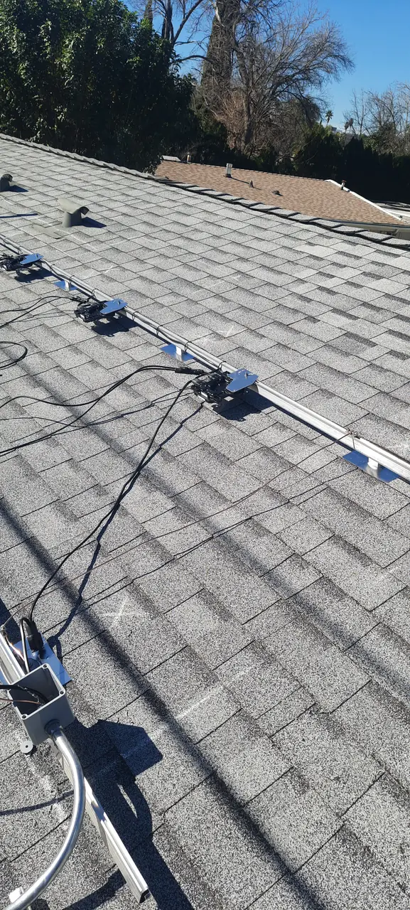 Solar panel mounting detail on a composition shingle roof in Canoga Park, CA