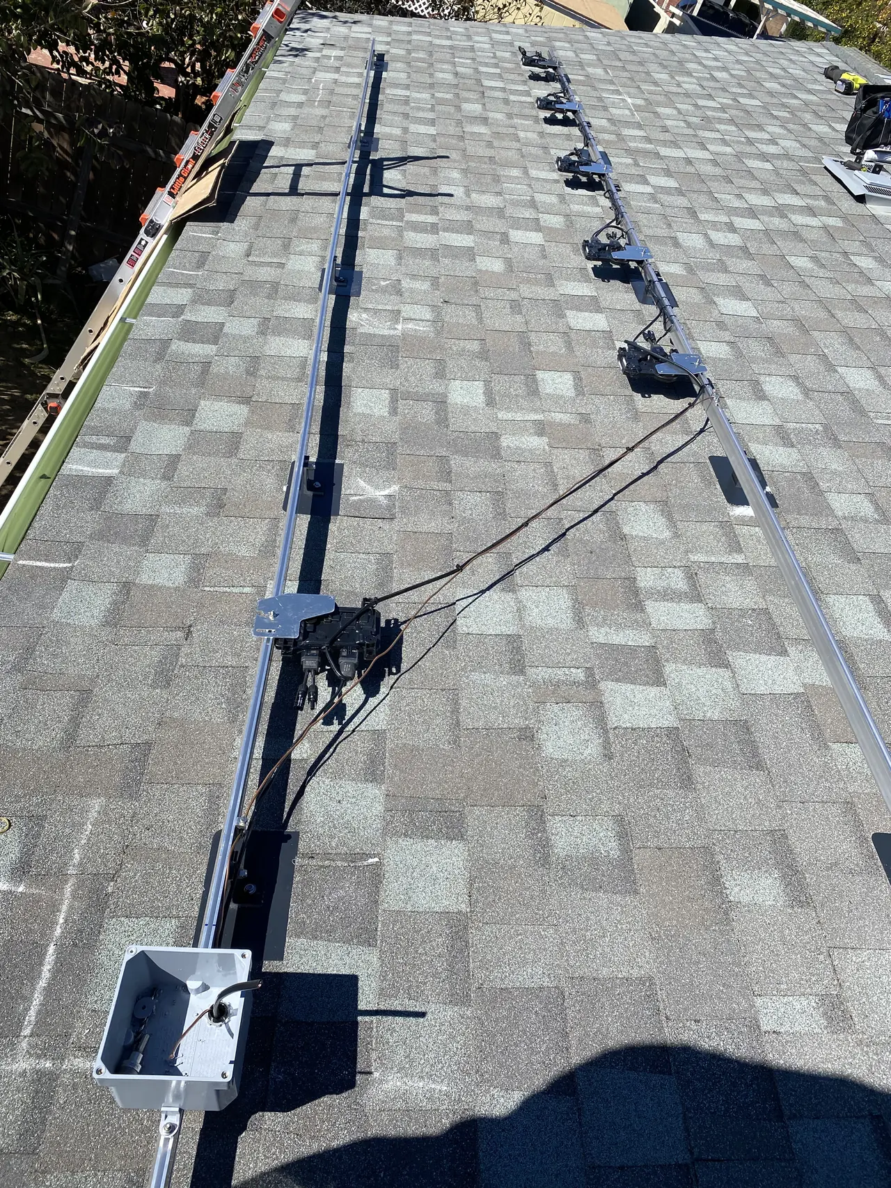 Mounting rails and a junction box on a composition shingle roof, Canoga Park