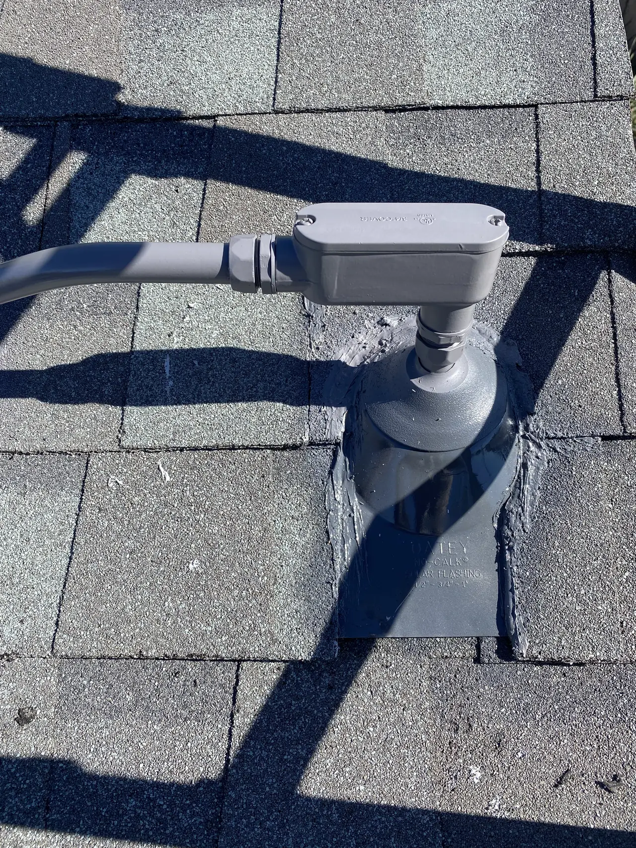 Lead pipe flashing set into composition shingle courses, Canoga Park