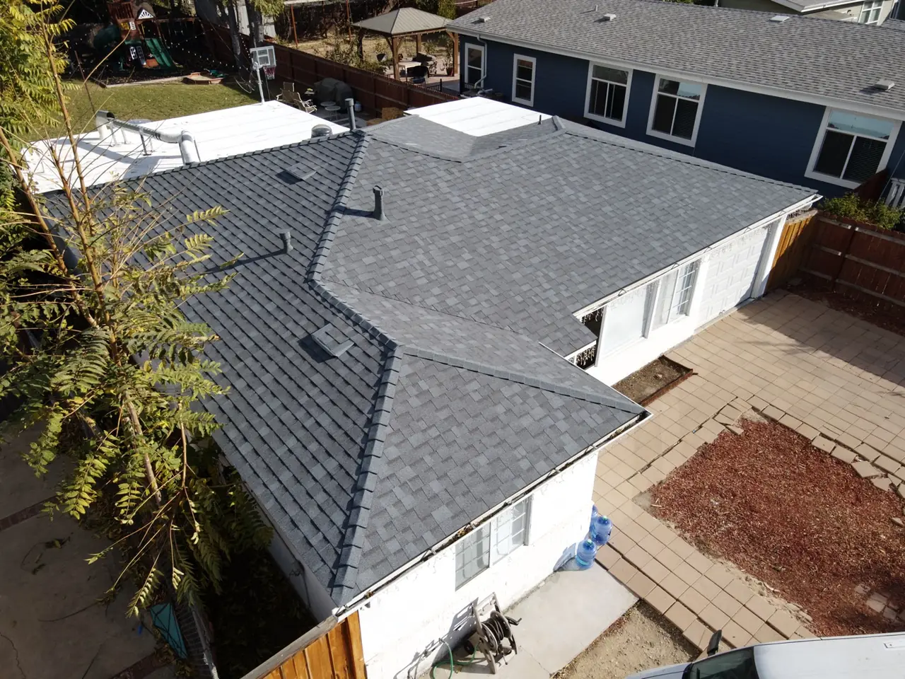 Finished shingle roof seen at an angle with a low-slope section beside it, Canoga Park