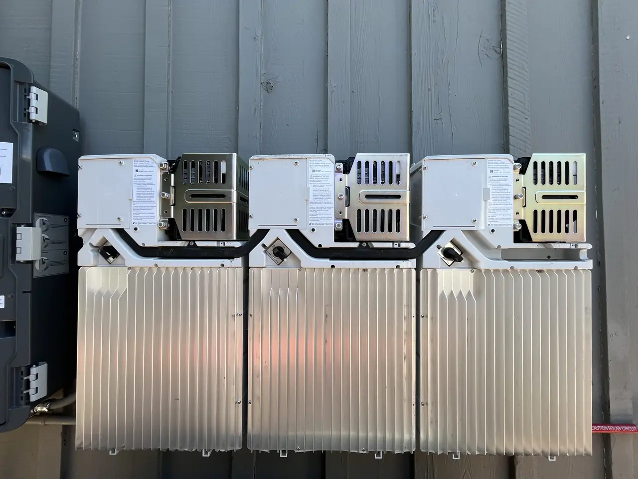 Inverter equipment mounted in a row on an exterior wall, Chatsworth