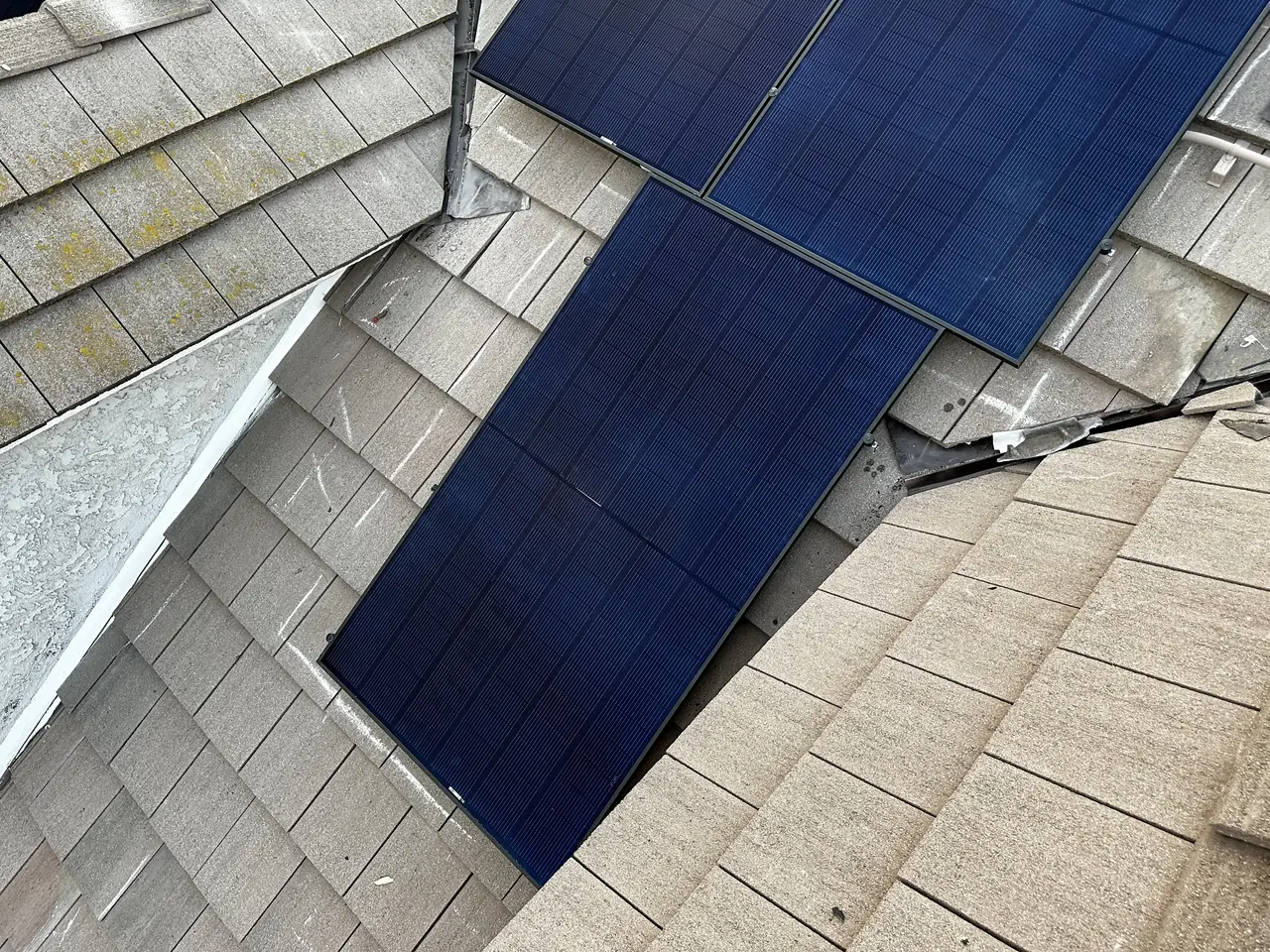 Solar modules on a roof plane with clay tile roofing visible beyond, Chatsworth