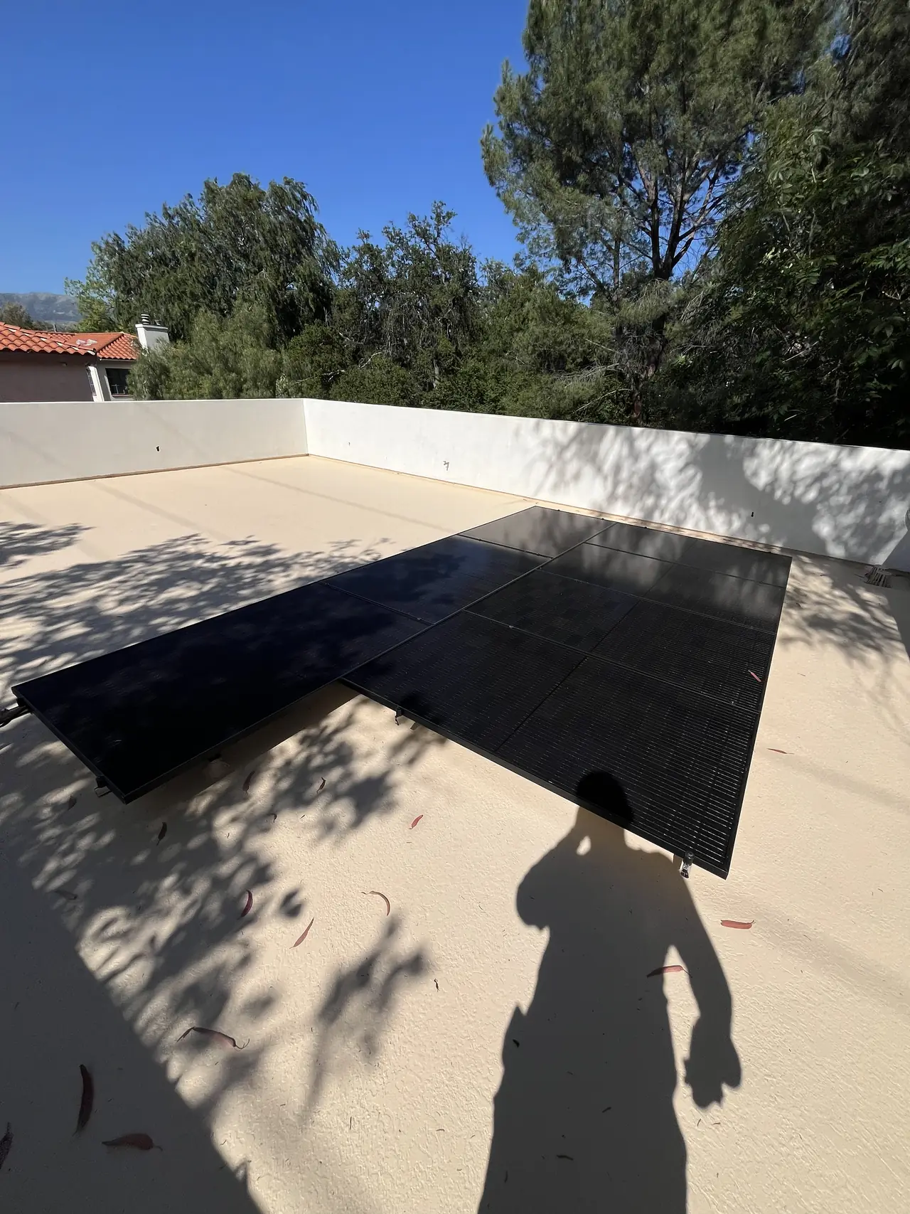 Flat roof with a solar array and a white parapet wall, Chatsworth