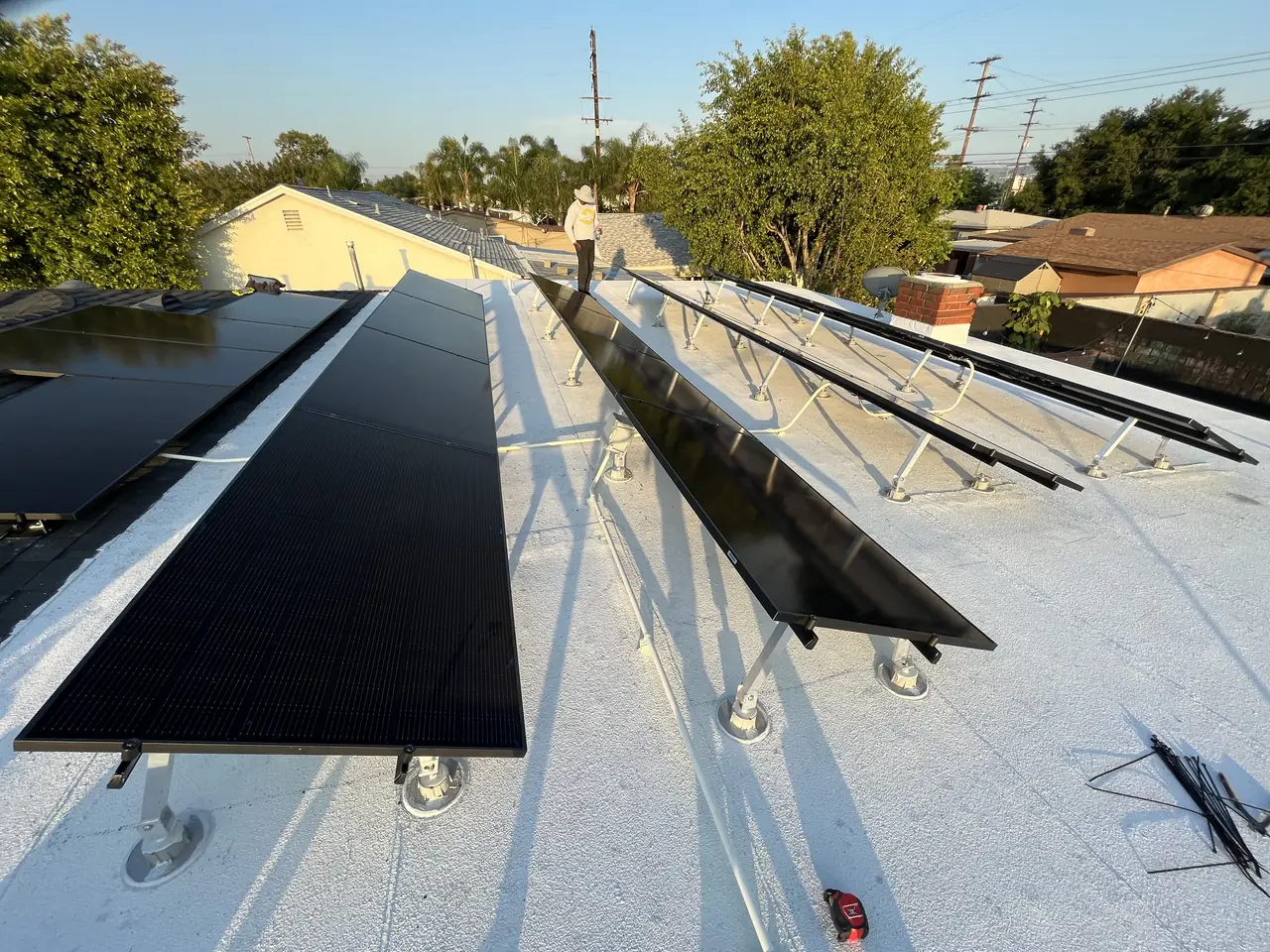 Tilt-up solar rows on a white membrane flat roof in Covina