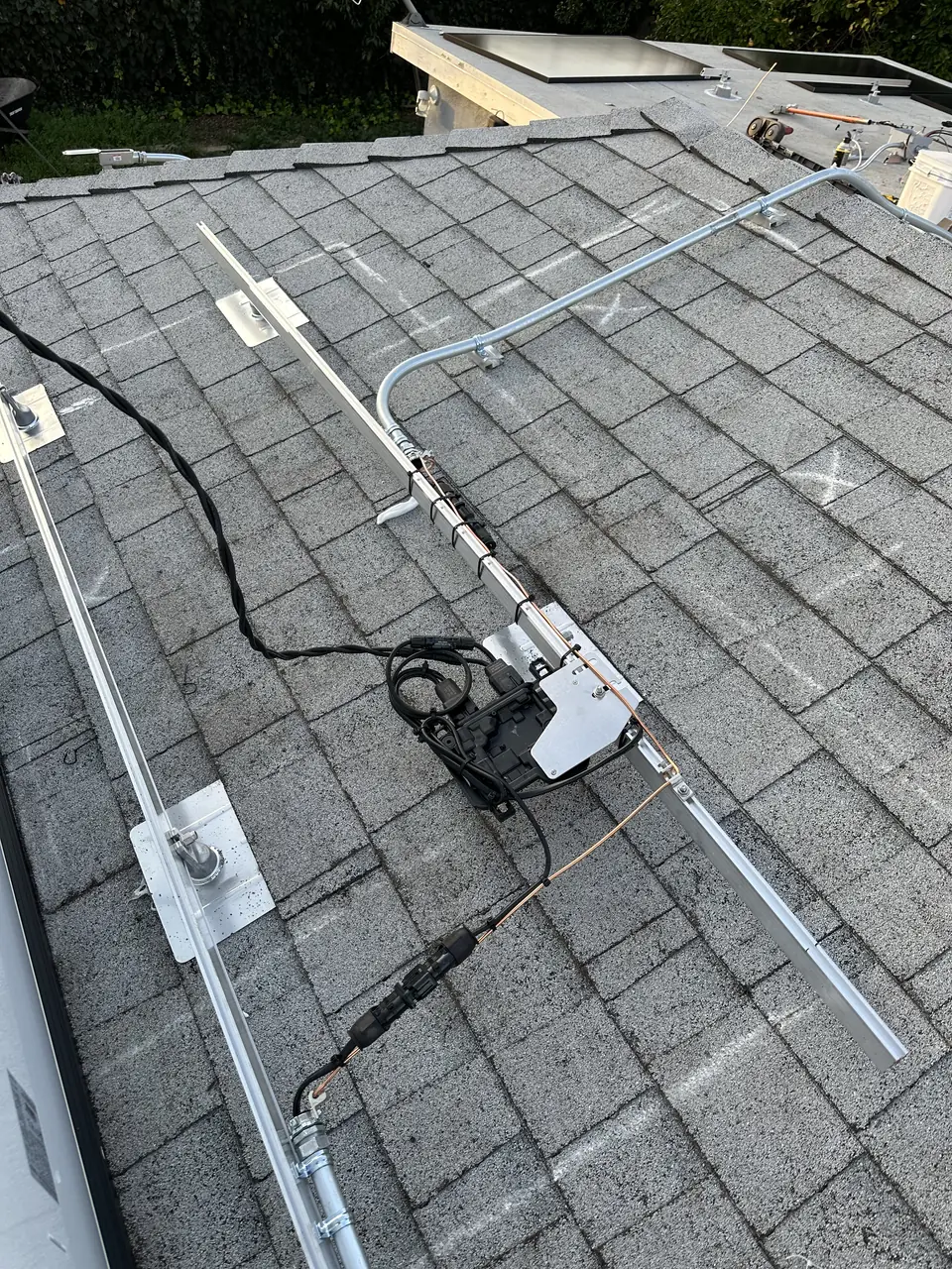 Solar panel mounting detail on a composition shingle roof in Encino, CA