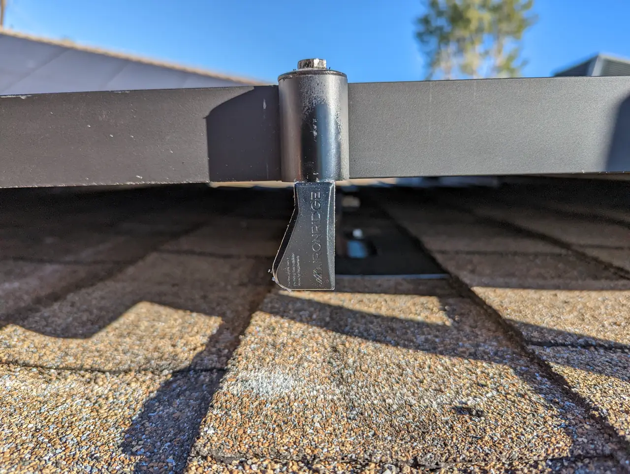 Close view of a standoff and rail mounted through composition shingle, Encino