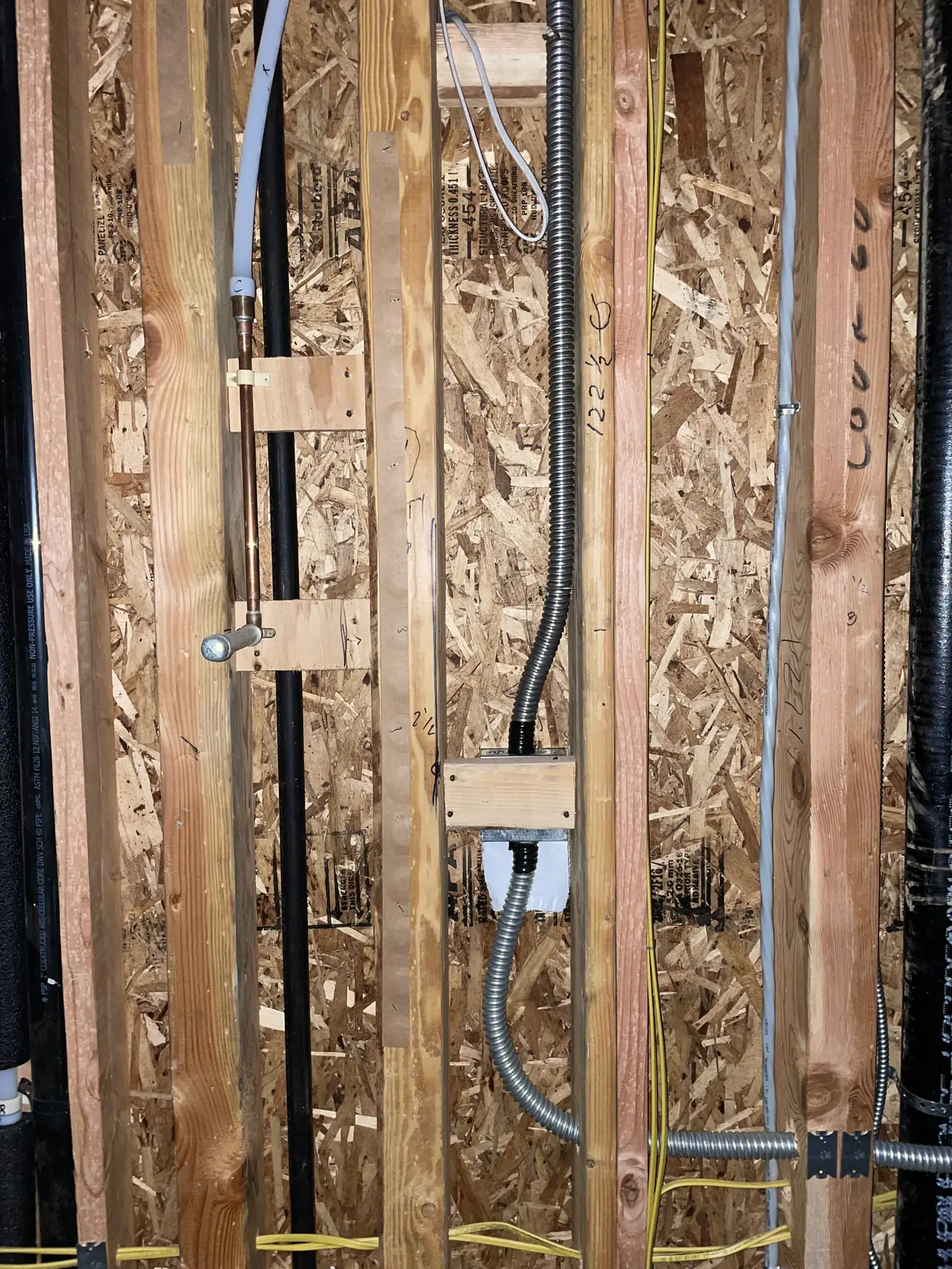 Conduit and an electrical box in open stud framing before drywall, Encino