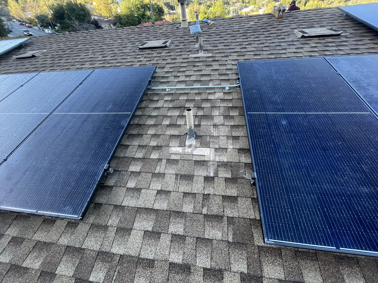 Solar panel mounting detail on a composition shingle roof in Glendale, CA