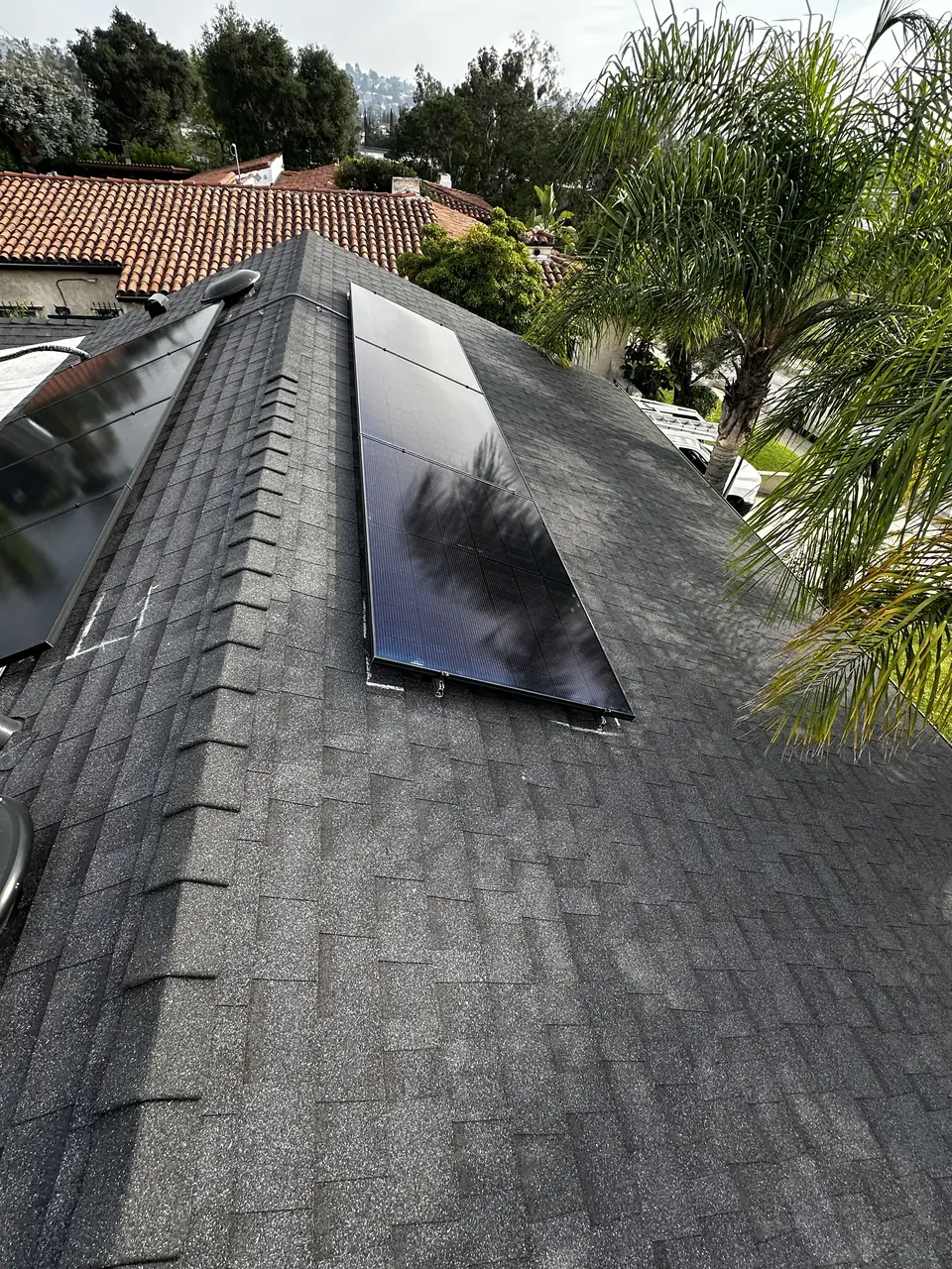 Solar panel mounting detail on a composition shingle roof in Glendale, CA