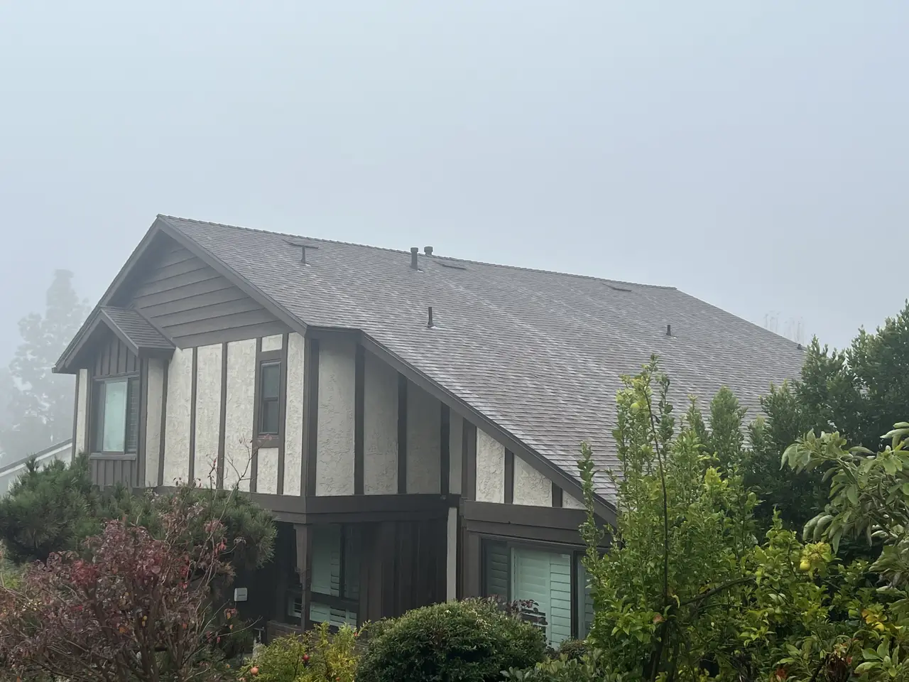 Two-story house with a new composition shingle roof on a hillside, Glendale