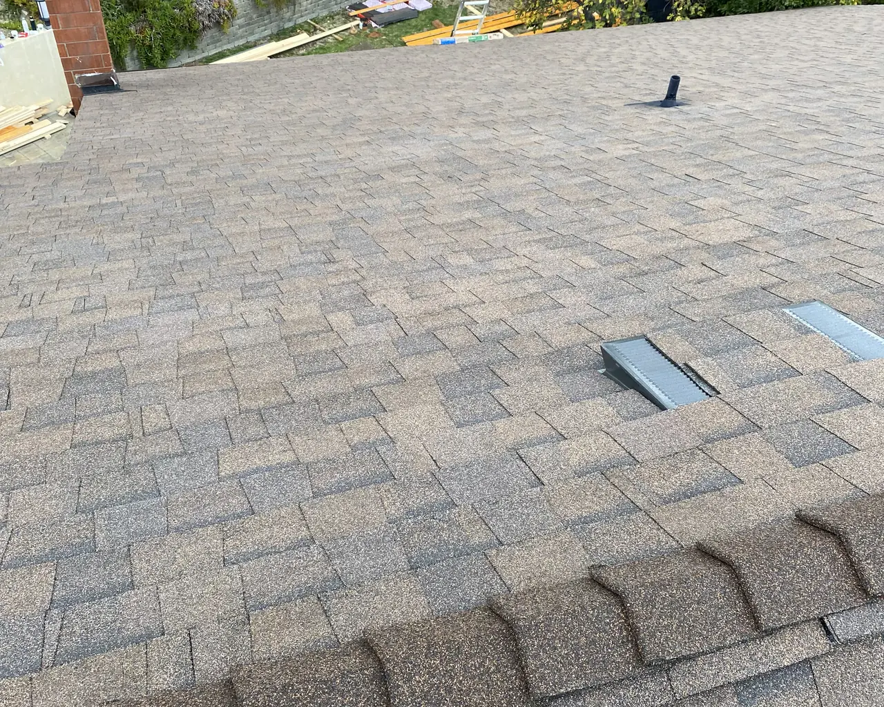 New composition shingle roof with low-profile vents and hills beyond, Glendale