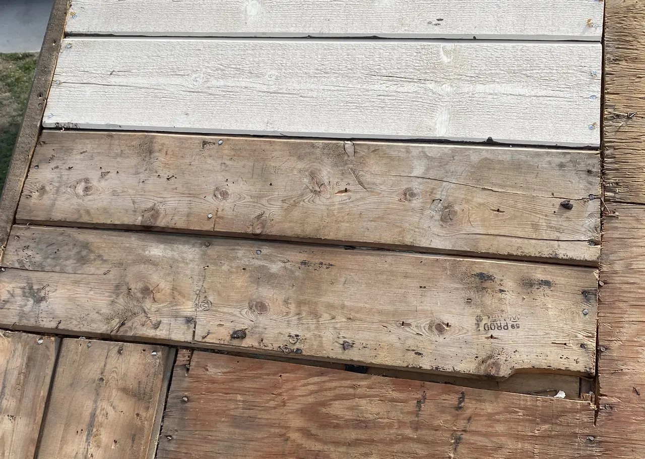 Roof deck with old planks and new replacement boards before the underlayment, Glendale