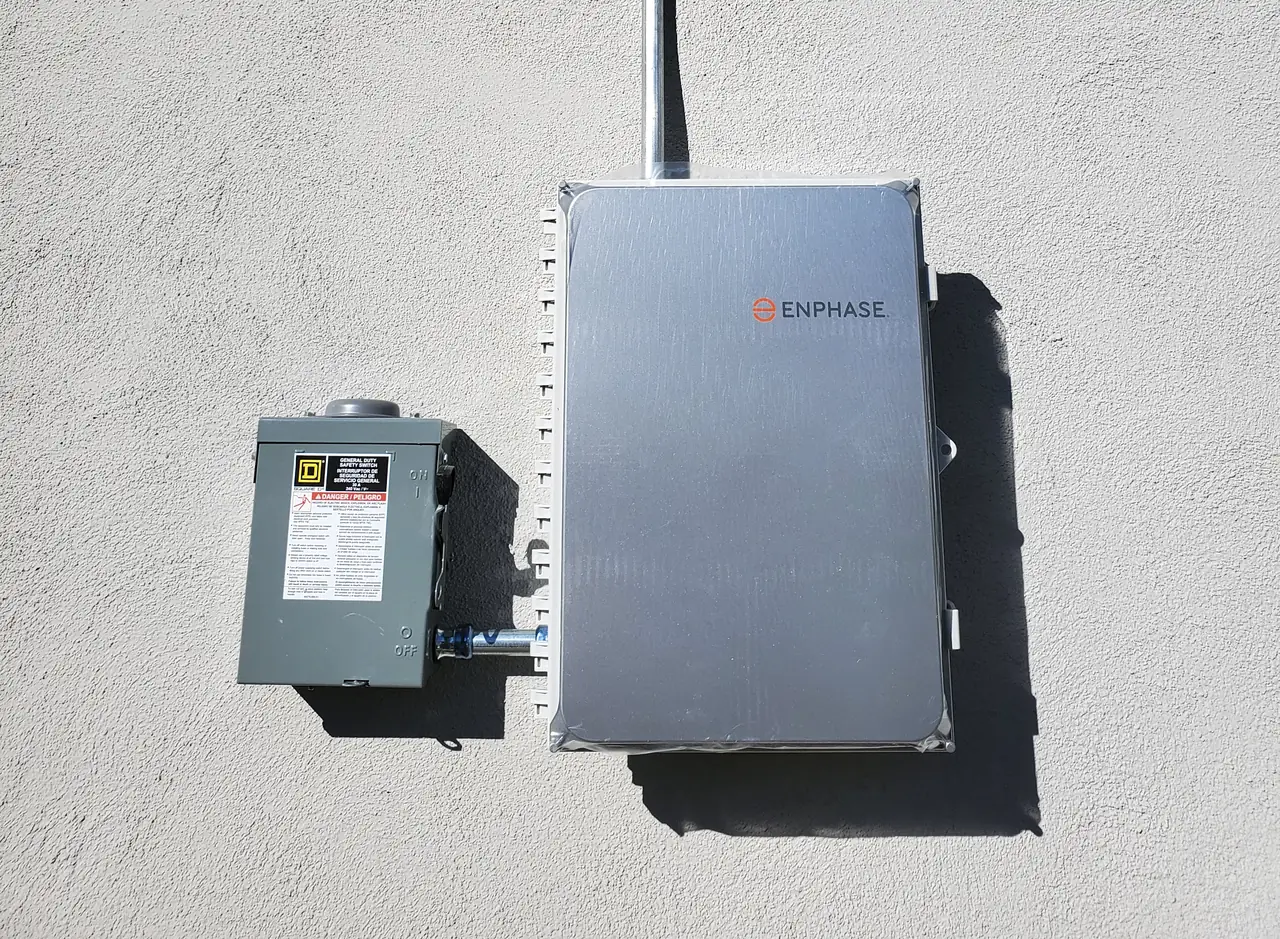 Solar combiner and a fused disconnect mounted on a stucco wall, Glendale