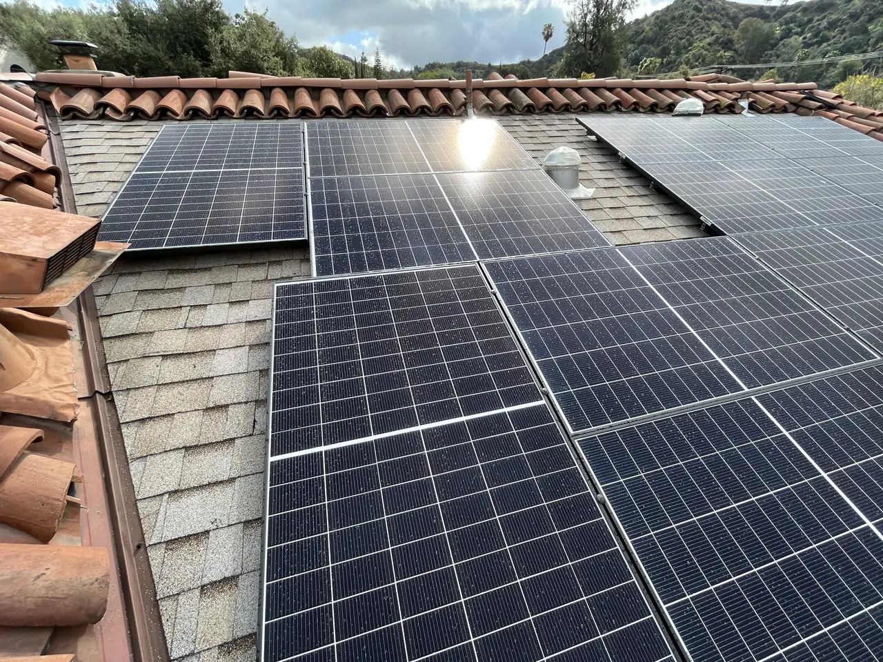 Solar modules on a shingle field bordered by clay barrel tile, Glendale