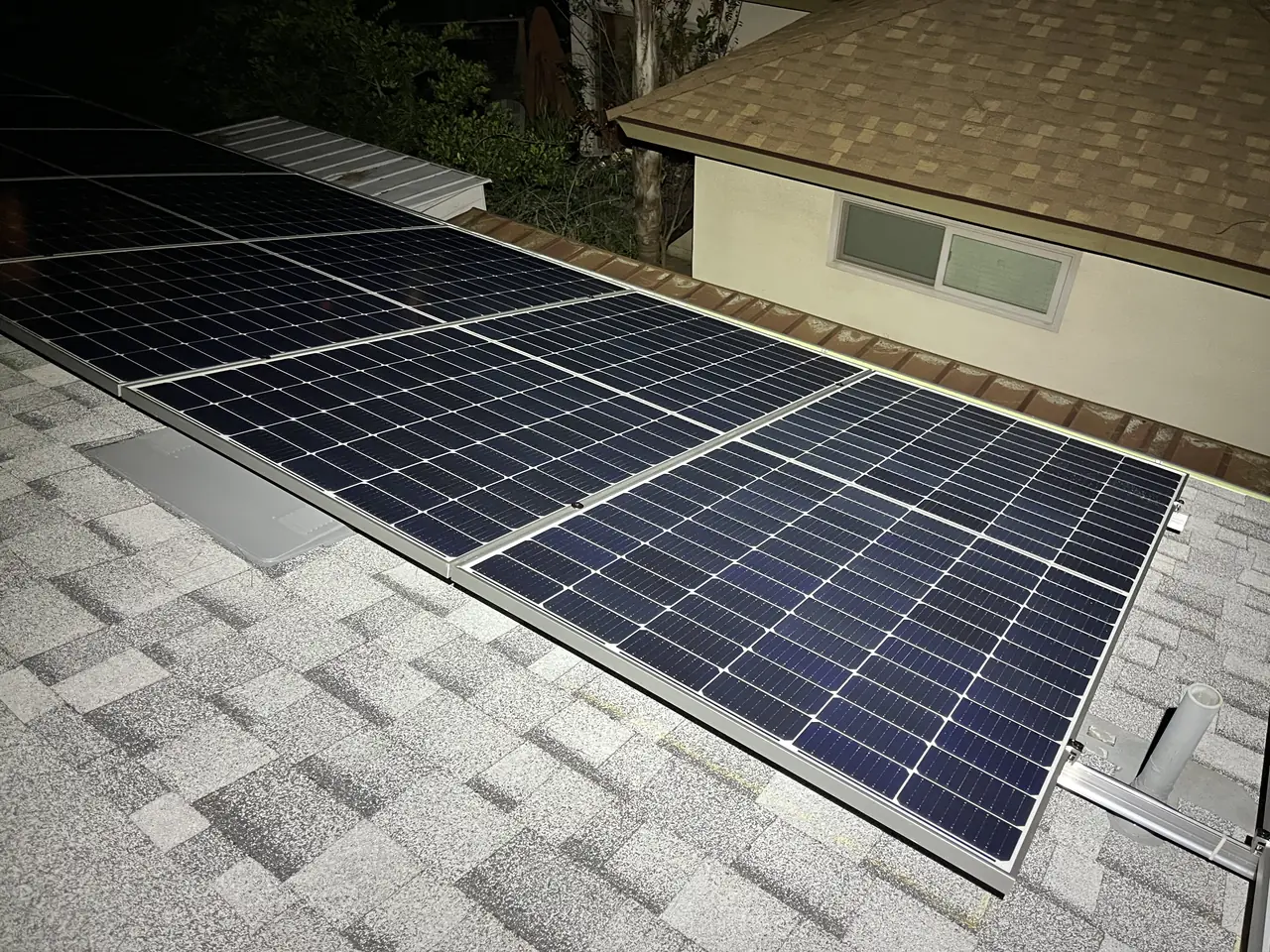 Two groups of solar modules on adjoining planes of a shingle roof, Glendale