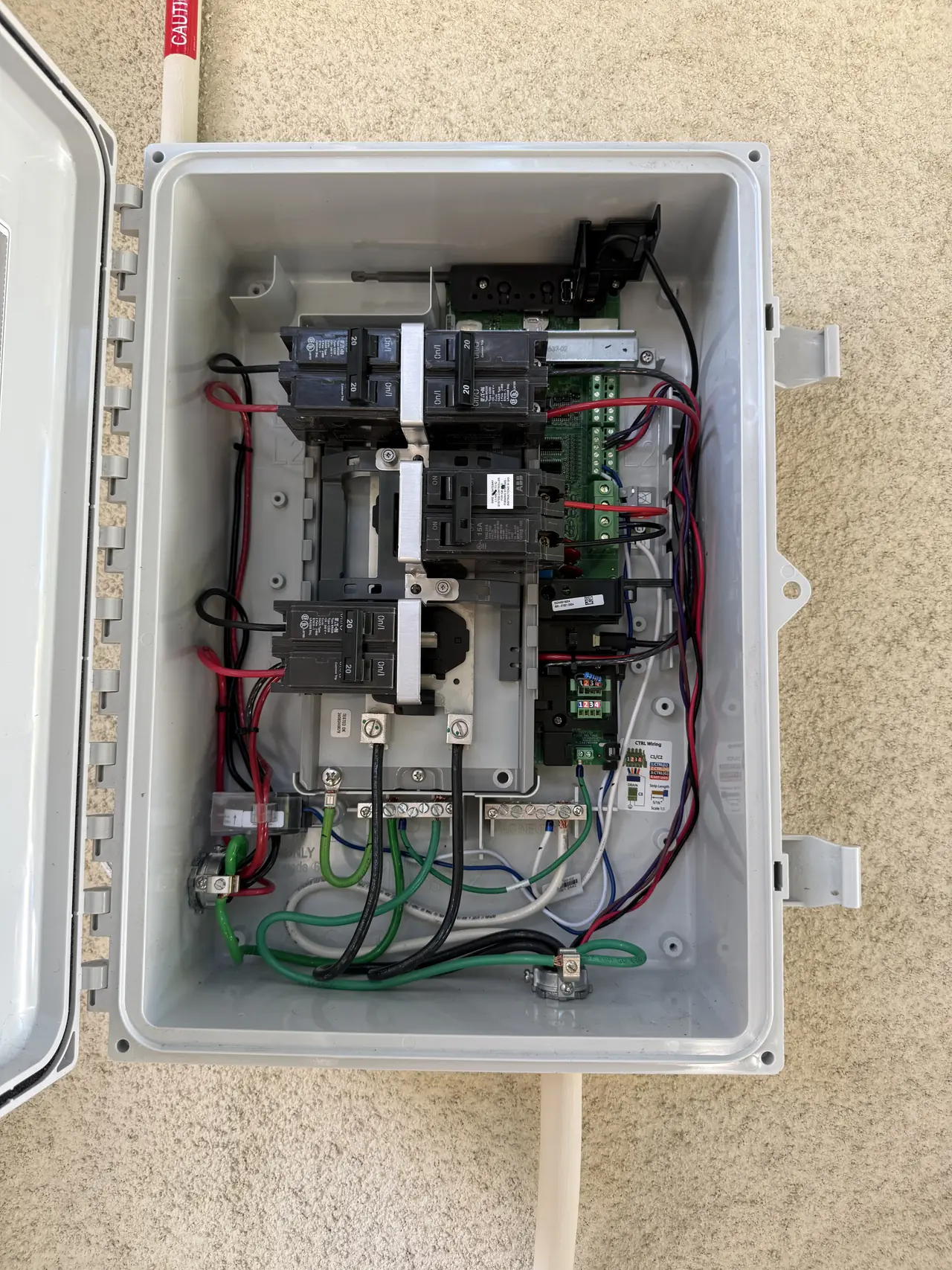 Open Enphase combiner enclosure with breakers and wiring, Granada Hills