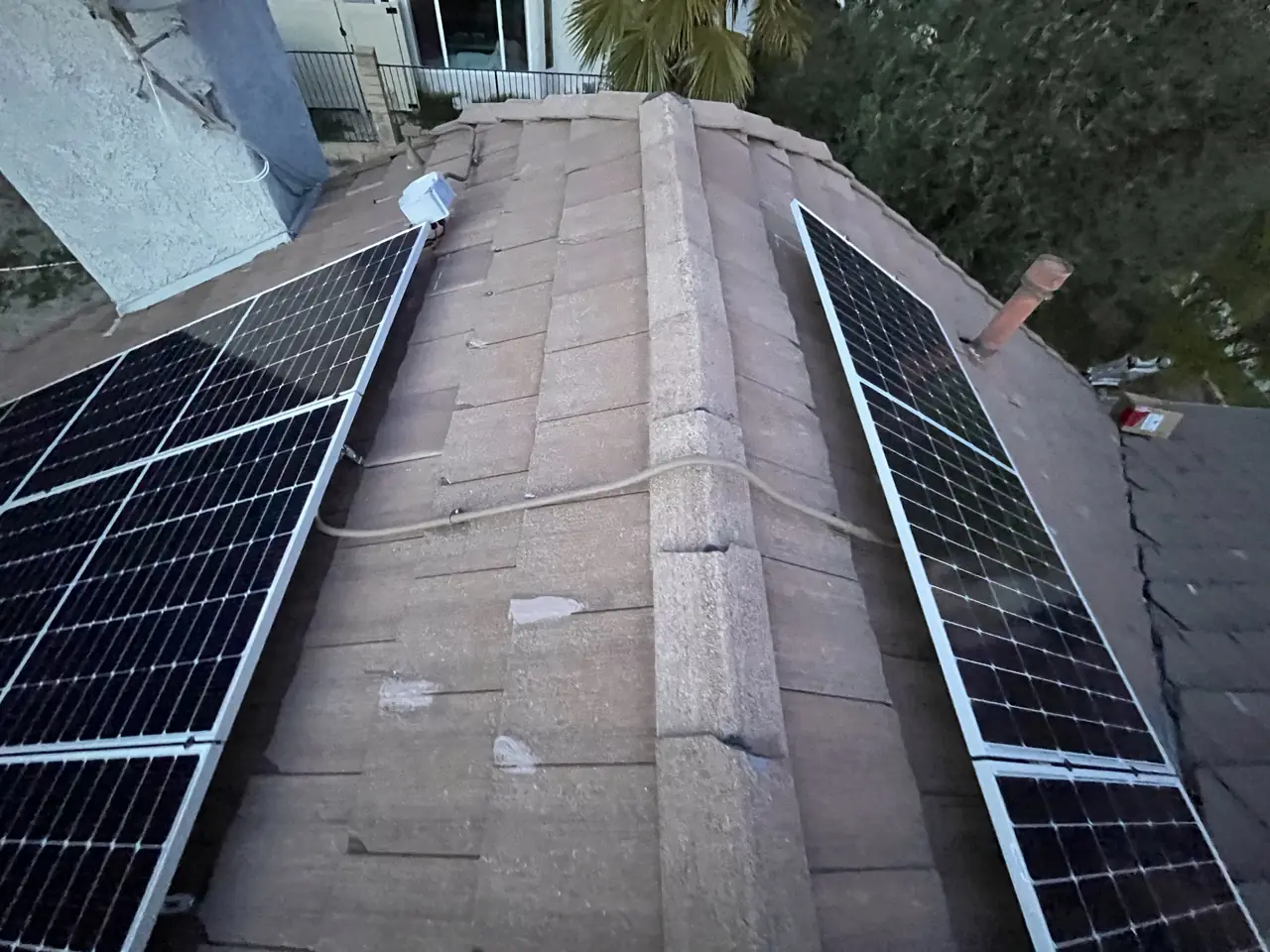 Solar modules set back from both sides of a tile roof hip, leaving a clear pathway up the middle, Granada Hills