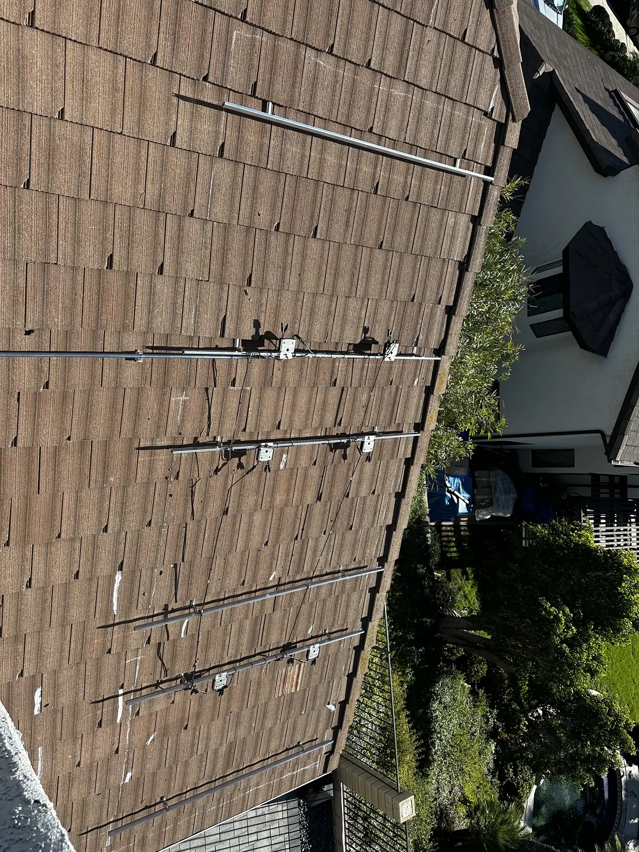 Mounting rails and attachments fixed to a bare concrete tile roof before the modules go on, Granada Hills