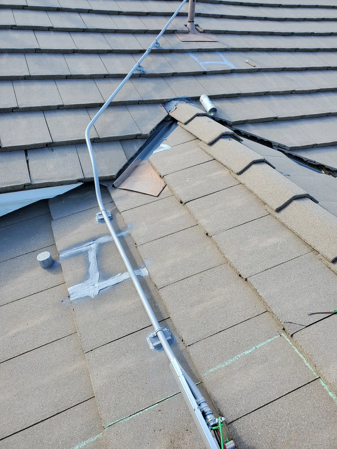 Electrical conduit running across a concrete tile roof between planes, with hills beyond, Granada Hills