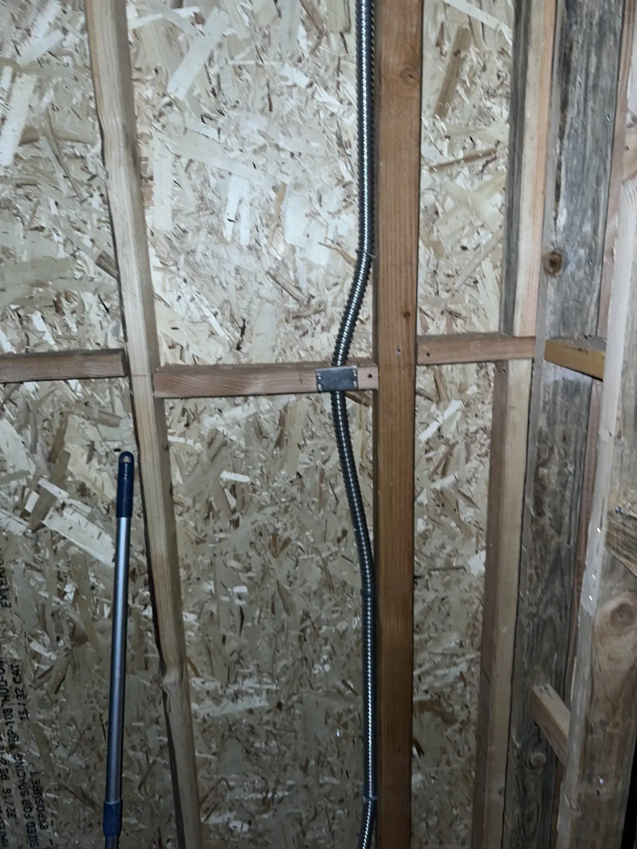 Electrical conduit running through the open framing of a building under construction, Granada Hills