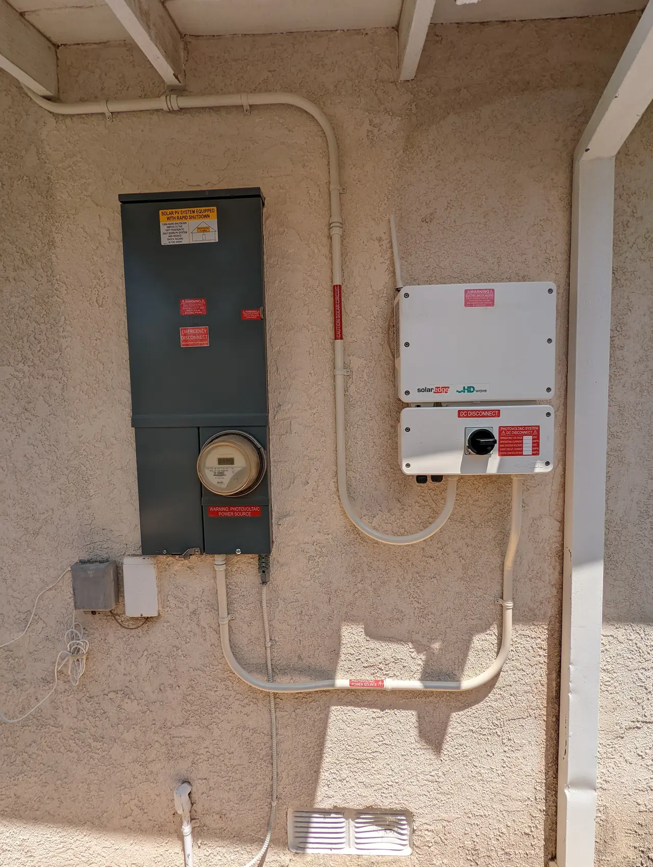 A service panel and inverter mounted together on an exterior wall, Granada Hills
