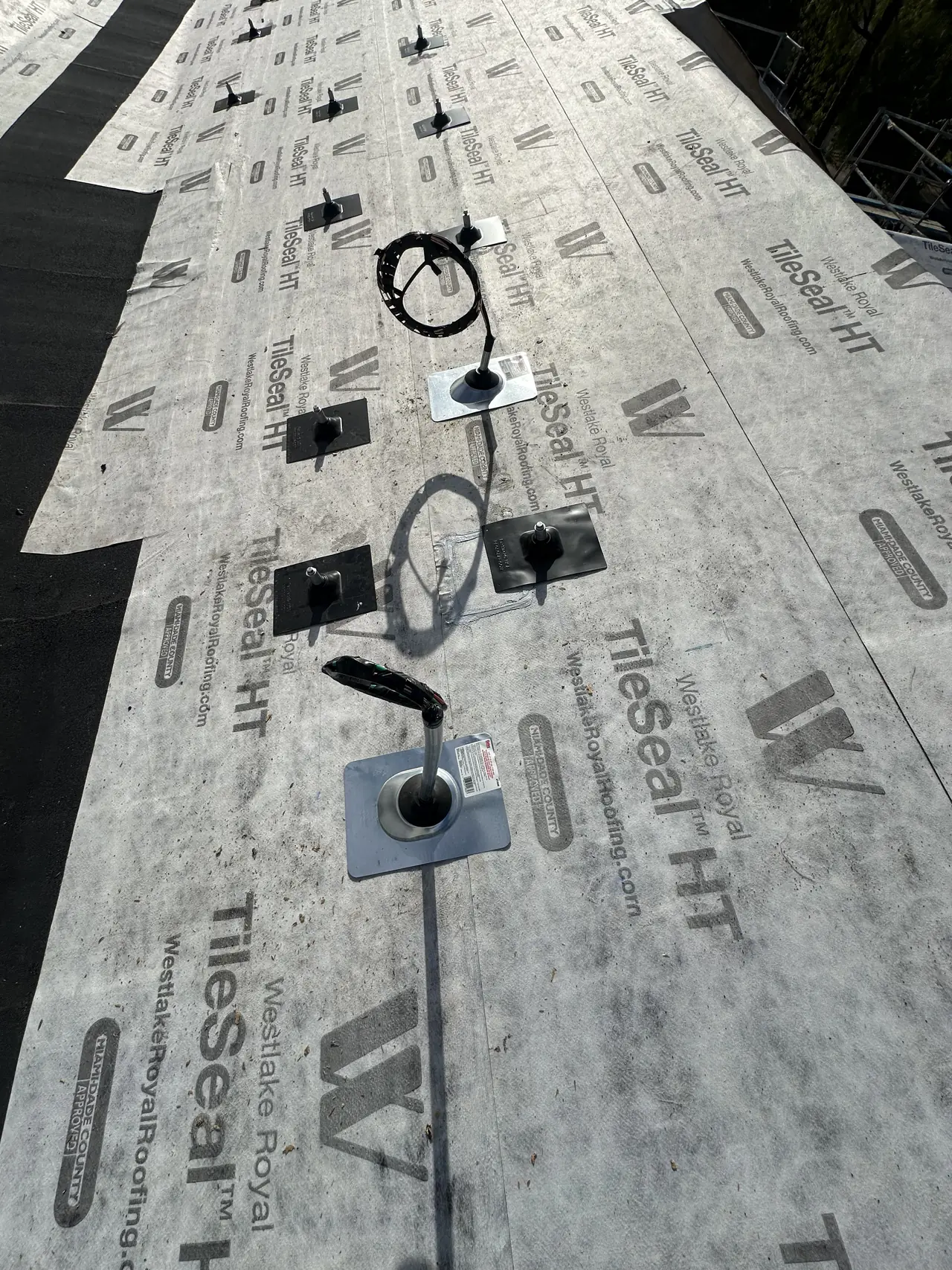 Solar mount flashings and a conduit penetration set on roofing underlayment before the roof covering, Hidden Hills