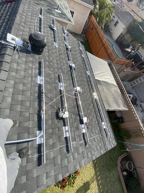 Solar panel mounting detail on a composition shingle roof in Lakewood, CA