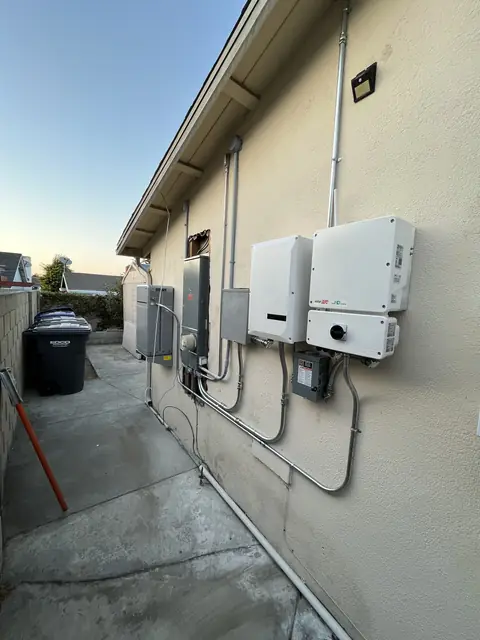Solar panel mounting detail on a composition shingle roof in Lakewood, CA