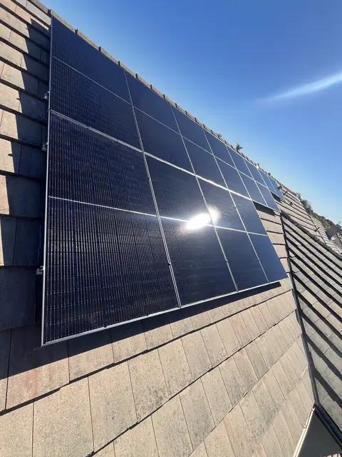 Solar panel mounting detail on a composition shingle roof in Lakewood, CA