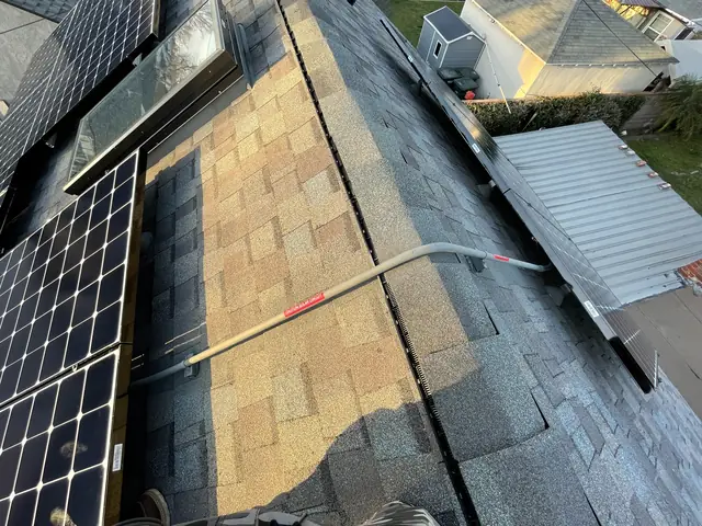 Solar panel mounting detail on a composition shingle roof in Lakewood, CA