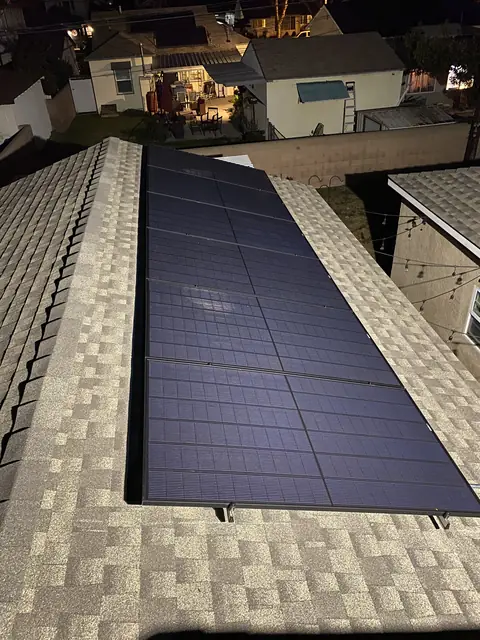 Solar panel mounting detail on a composition shingle roof in Lakewood, CA