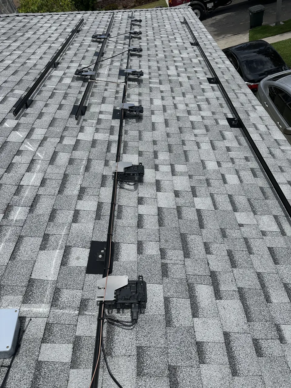 Solar panel mounting detail on a composition shingle roof in Lakewood, CA