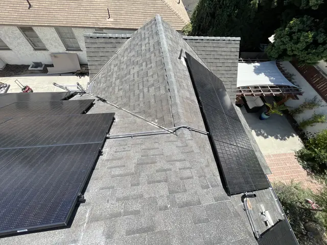 Solar panel mounting detail on a composition shingle roof in Long Beach, CA