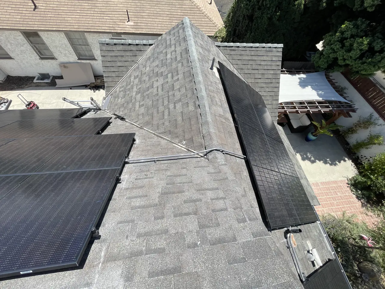 Twenty all-black panels on a steep multi-slope roof in Long Beach