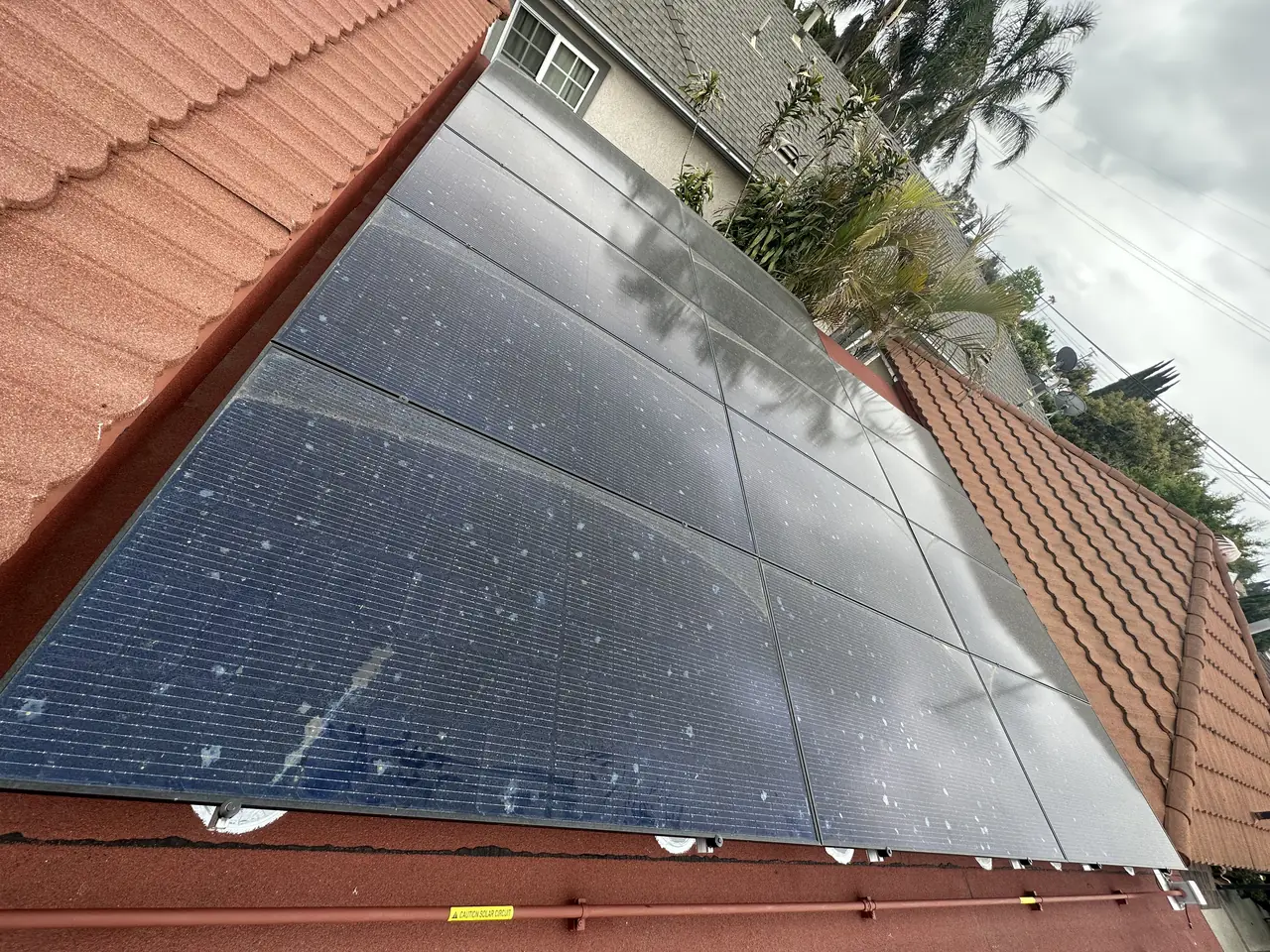 Solar panel mounting detail on a tile roof in Long Beach, CA