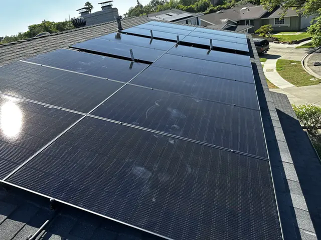 Solar panel mounting detail on a composition shingle roof in Long Beach, CA