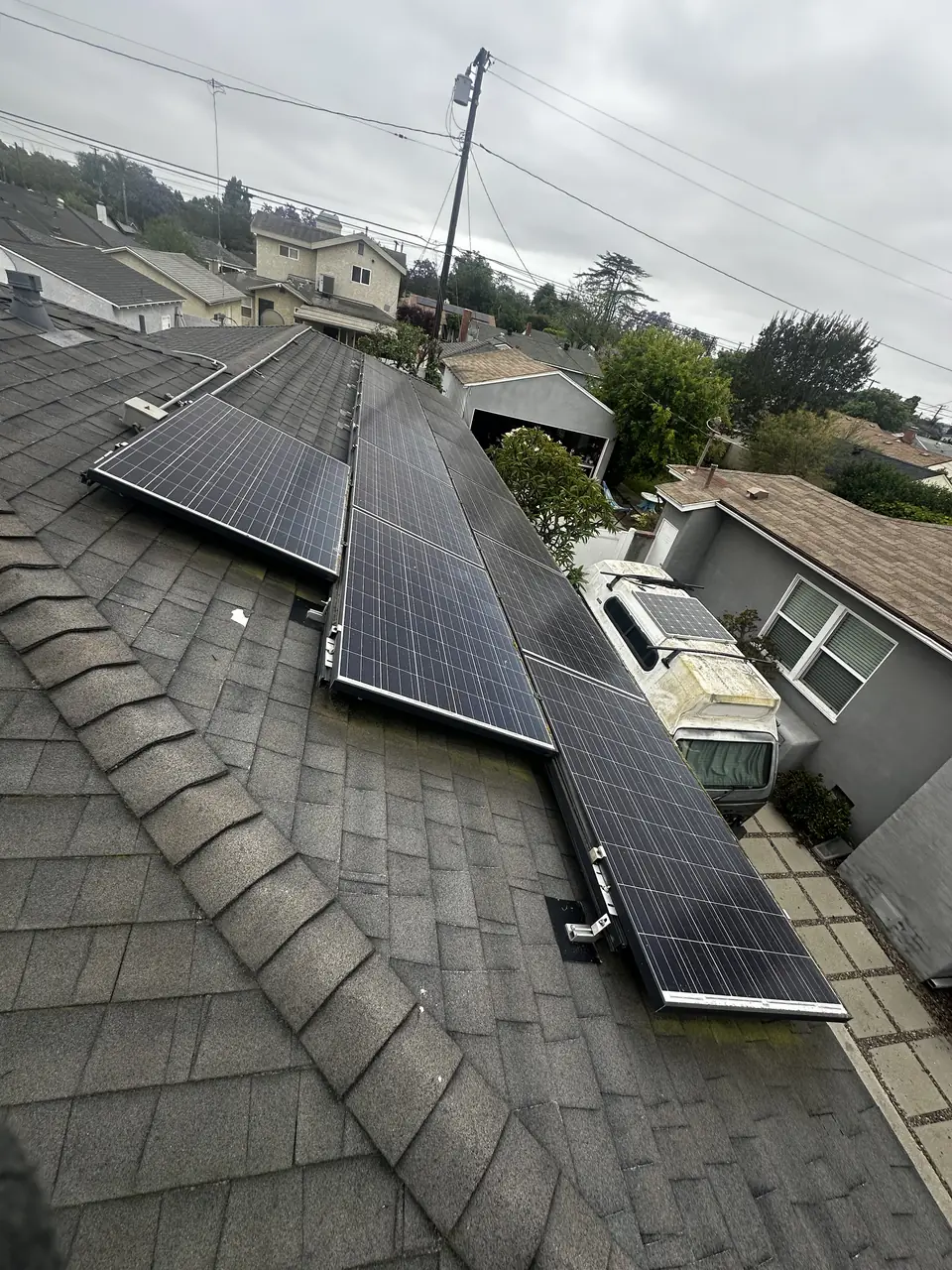 Solar panel mounting detail on a composition shingle roof in Long Beach, CA