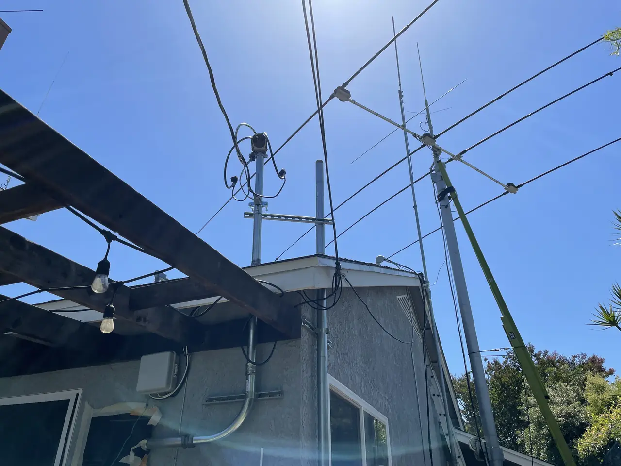 A view upward from the yard to the overhead service wires and the edge of the roof, Long Beach